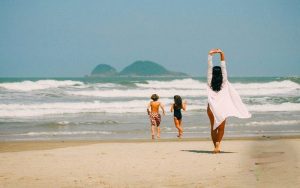 Mother with two children on the beach in Brazil