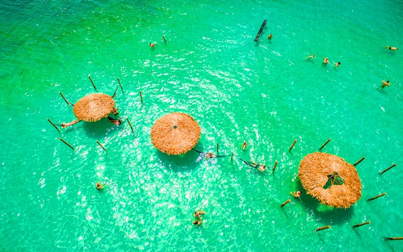 hammocks and beach umbrellas in the green waters of Lagoa do Paraiso in Jericoacoara, in the north-east of Brazil