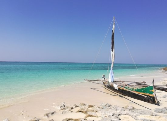 wooden pirogue on the white sands of Andavadoaka beach in Madagascar